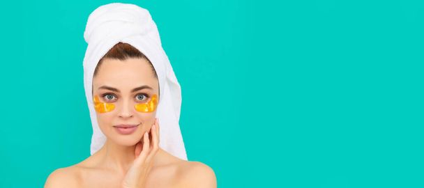 Eye patches, patch under eyes. smiling young woman with golden collagen patch on face skin. Beautiful woman isolated face portrait, banner with mock up copy space - Photo, Image