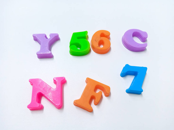 Kid Toys background. Plastic magnetic letters isolated on white, top view. - Foto, afbeelding