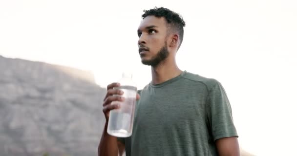 Mexican man, drinking water after running in city with mountain, hydration and outdoor with fitness. Thirsty after run, athlete and cardio with health, h2o with wellness, exercise and healthy life. - Footage, Video