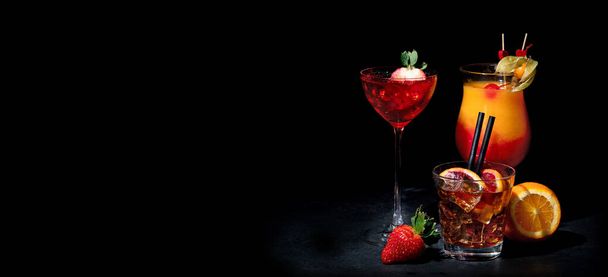 Set of various colorful cocktails on black background. Classic long drink cocktails menu concept. Copy, space - Foto, afbeelding
