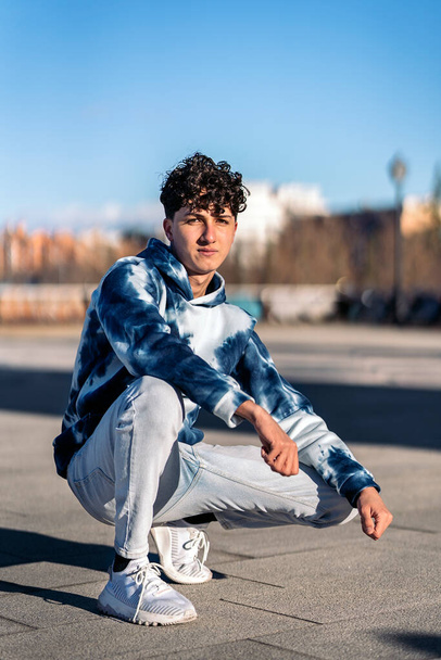 Stock photo of serious boy wearing urban clothes posing and looking at camera. - Foto, imagen