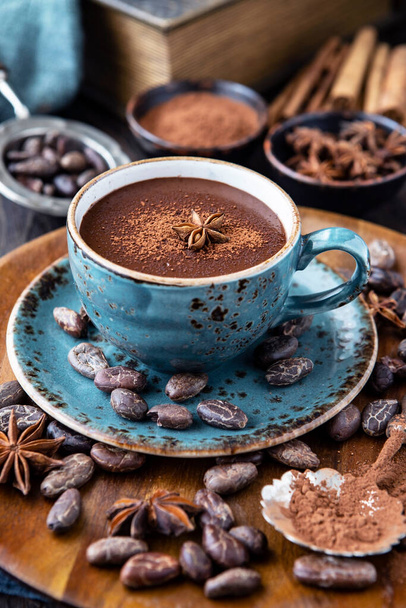 Thick spicy hot chocolate in  ceramic cup on  wooden background - Photo, image