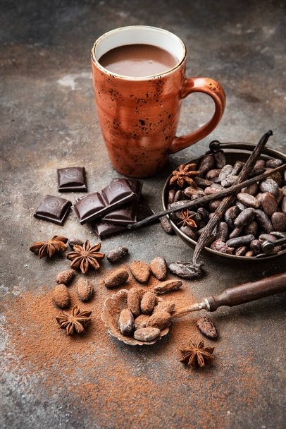 Homemade spicy hot chocolate with cinnamon in  ceramic mug on dark concrete background - Foto, Bild