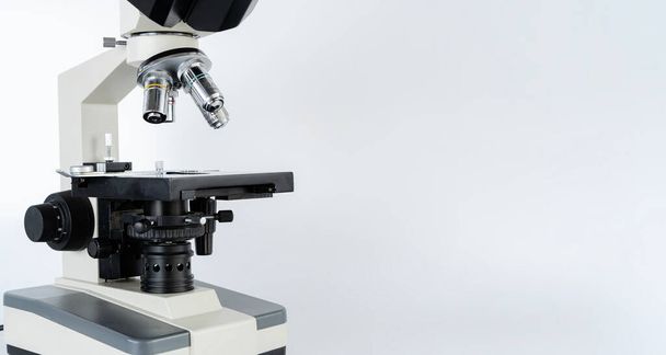Black metal optical microscope with petri dish side view isolated on background. Slit lamp and biomicroscope binoculars. Modern ophthalmic equipment. Background - Valokuva, kuva
