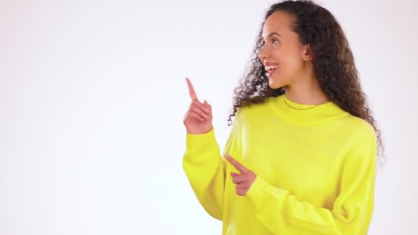 Pointing, mockup and smile with black woman in studio for advertising, product placement and promotion. Sales, happy and information with girl and positive gesture for choice, news and announcement. - Footage, Video