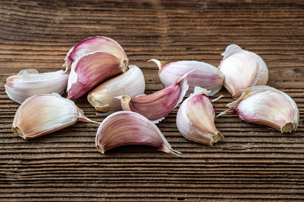 Garlic on dark rustic wooden background. - Zdjęcie, obraz