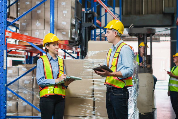 Workers team working in warehouse, Manager and supervisor taking inventory in warehouse, Female foreperson making plans with warehousemen - Foto, Imagem