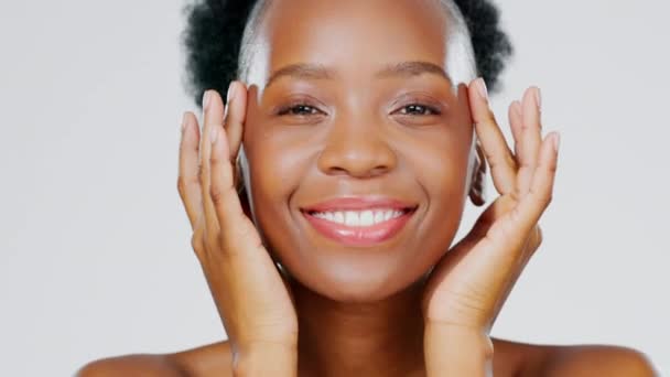 Face, black woman and smile for beauty and skincare glow, happy model and cosmetic care on studio background. Moisturizer, female hands and skin, dermatology with luxury spa treatment in portrait. - Footage, Video