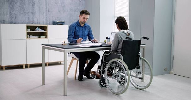 Businesswoman ith Disability Sitting On Wheelchair In Office - Φωτογραφία, εικόνα