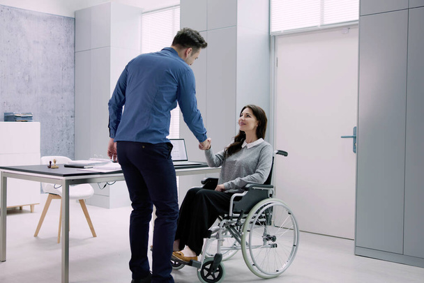 Person In Wheel Chair Handshake. Professional Consulting Job - Фото, изображение