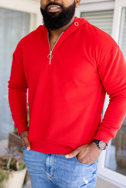 African american man wearing red sweatshirt with copy space. Fashion, design, color and clothes concept. - Foto, Imagem