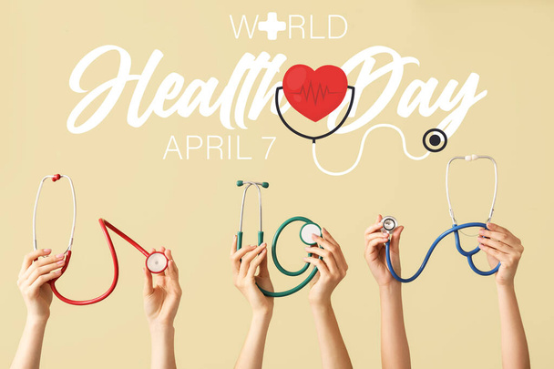 Many hands with stethoscopes on beige background. World Health Day - Photo, Image