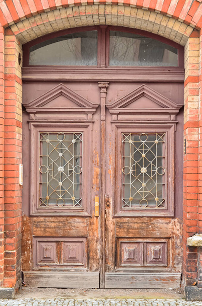 Вид на кирпичное здание со старой деревянной дверью - Фото, изображение