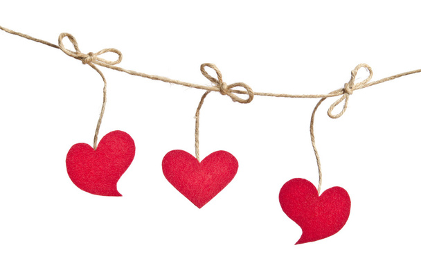 Three Red fabric hearts hanging on the clothesline isolated on w - Φωτογραφία, εικόνα