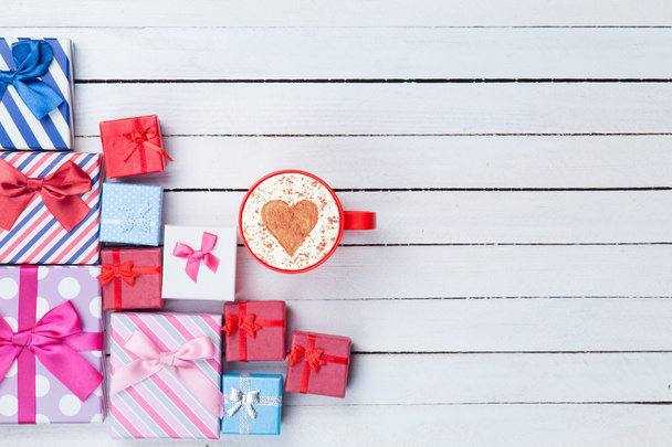 Cup of Cappuccino and gift boxes - Photo, Image