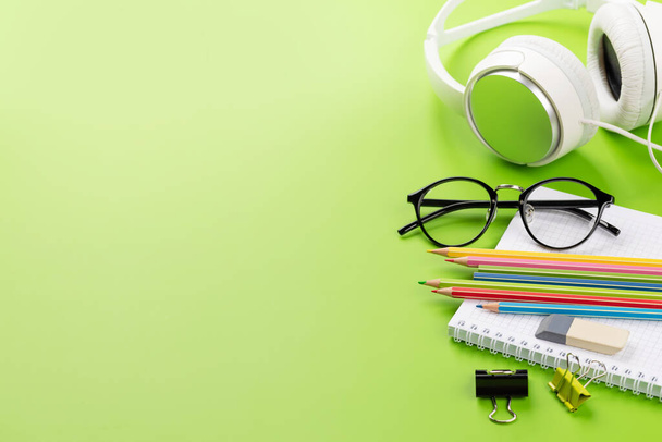 School supplies and stationery on green background. Wth blank space - Foto, imagen