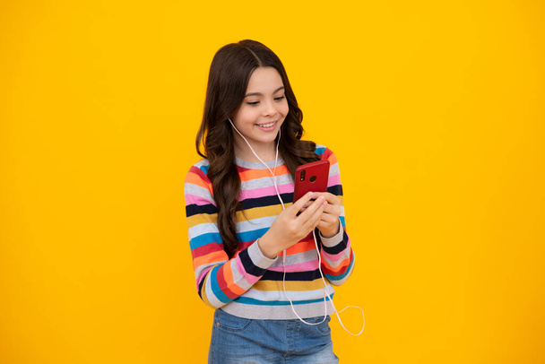 Ευτυχισμένο έφηβο κορίτσι 12, 13, 14 ετών με έξυπνο τηλέφωνο. Hipster έφηβος κορίτσι πληκτρολογεί μήνυμα στο κινητό, απολαμβάνει το κινητό app. Το παιδί κρατάει smart sms στα online social media. Εθισμός στο Διαδίκτυο - Φωτογραφία, εικόνα