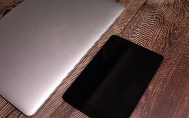 Modern laptop and digital tablet on wooden table, top view  - Φωτογραφία, εικόνα