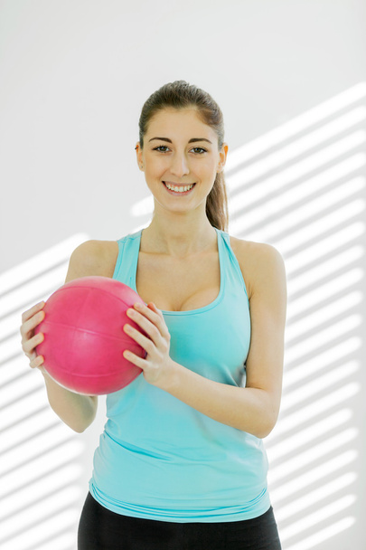 Portrait of smiling woman with a gym ball - Fotoğraf, Görsel