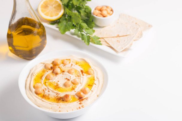 Hummus in a plate with chickpeas, smoked paprika, olive oil and  - Photo, Image