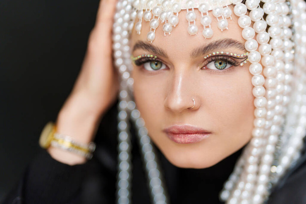 Close up portrait of a beauty caucasian sensual woman with make up and a wig of pearls - Photo, Image