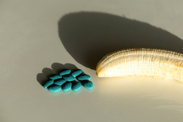 Impotence pills and a peeled fresh banana - Photo, Image
