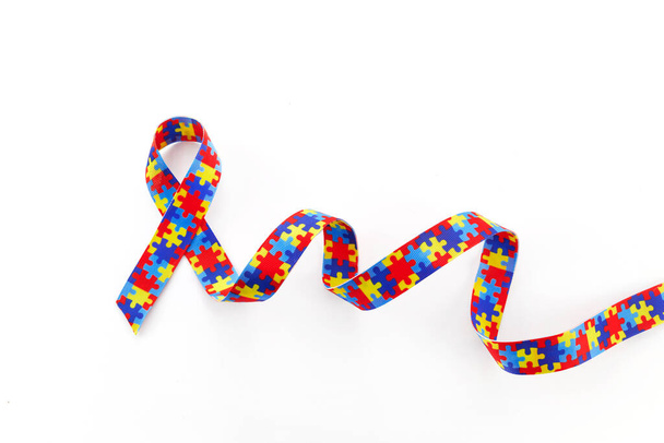 World Autism awareness and pride day or month with Puzzle pattern ribbon on white background. - Foto, immagini