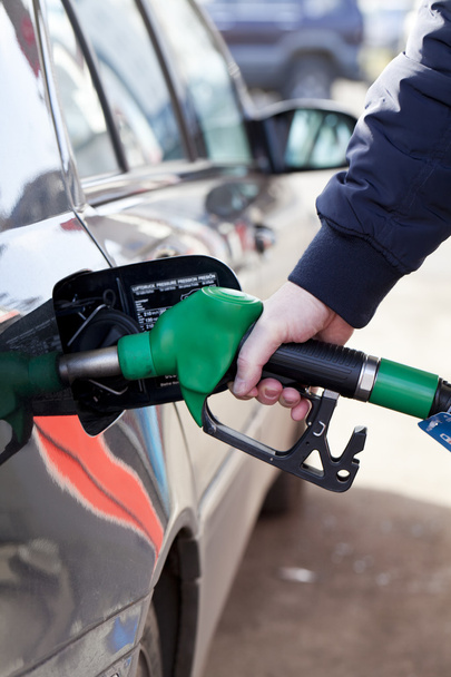 Man filling up car with fuel at petrol station - Фото, изображение