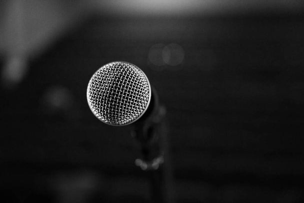 Mikrofon auf der Bühne für Sänger und Stand-up auf verschwommenem Hintergrund aus nächster Nähe - Foto, Bild