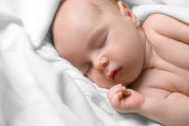 Cute newborn baby sleeping on white blanket, closeup - Фото, изображение