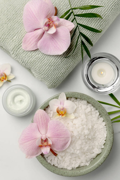 Flat lay composition with different spa products and flowers on white marble table - Foto, Imagem