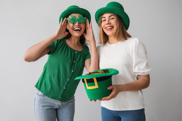 Young women with leprechaun's hat on light background. St. Patrick's Day celebration - Foto, Imagen