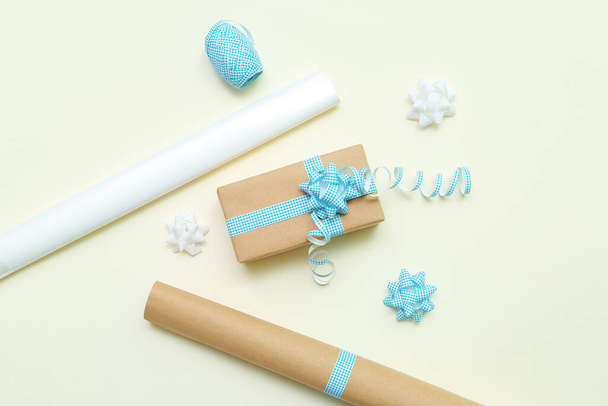 Gift box with bows and wrapping paper on light background - Fotografie, Obrázek