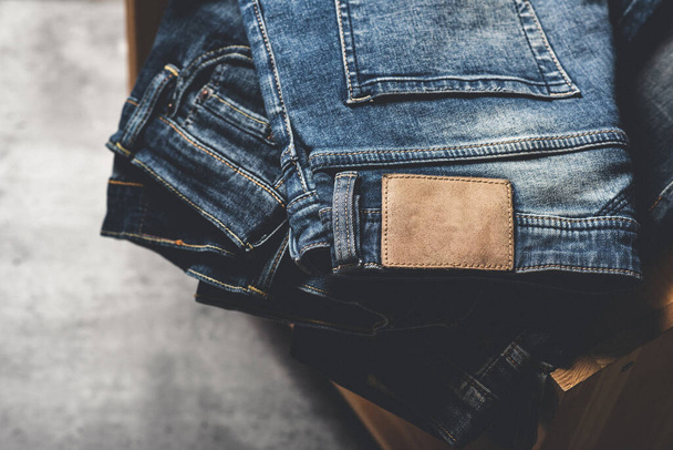 mnoho modrých džínů na betonovém pozadí. muži módní džíny džíny. - Fotografie, Obrázek