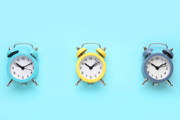 Alarm clocks on blue background - Photo, image