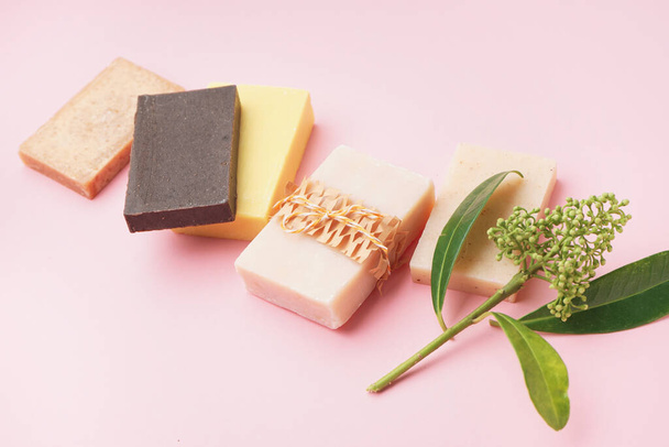 Set of natural soap bars and plant branch on pink background - Photo, Image