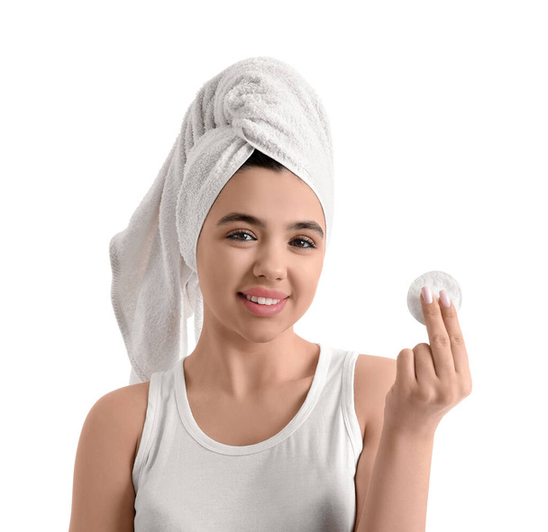 Young woman removing makeup with cotton pad on white background, closeup - Valokuva, kuva