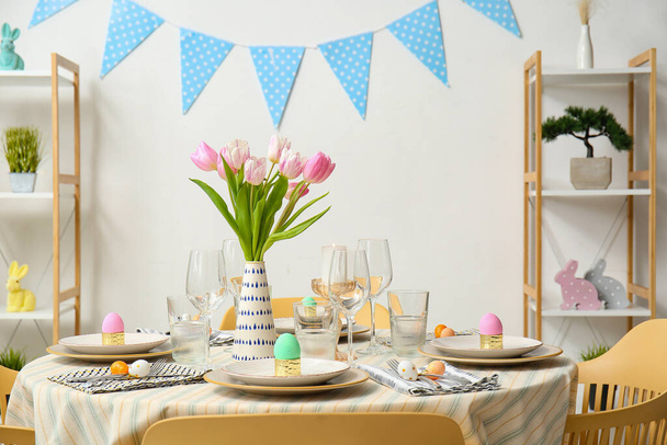 Interior of dining room with table served for Easter celebration - 写真・画像