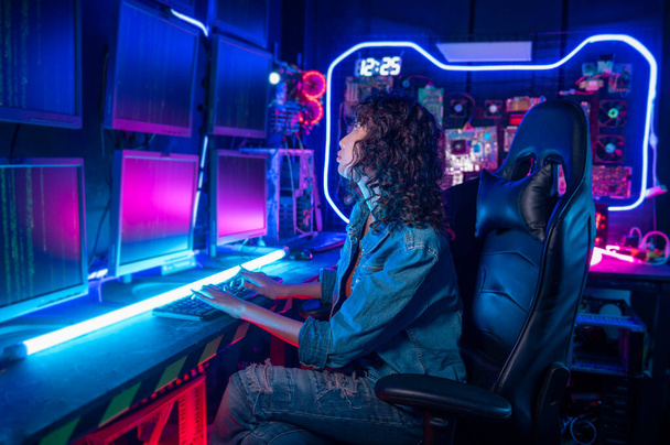 an asian woman programmer is working in her computer room , futuristic technology concept - Φωτογραφία, εικόνα