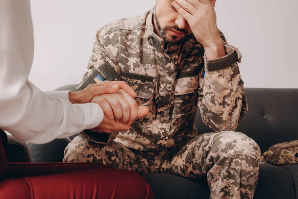 Psychologist supporting military officer in office, closeup - Foto, Bild