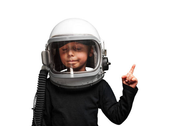 Small child wants to fly an airplane wearing an airplane helmet.  - Zdjęcie, obraz