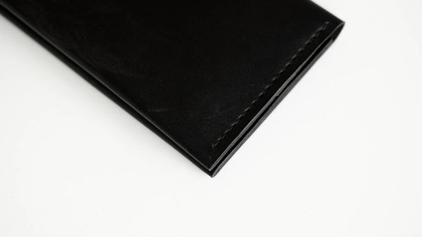 Details of black genuine leather wallet on a white background. Mens accessories - Fotoğraf, Görsel