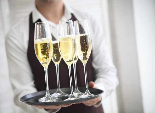 Professional male waiter in uniform serving champagne - Foto, Imagem