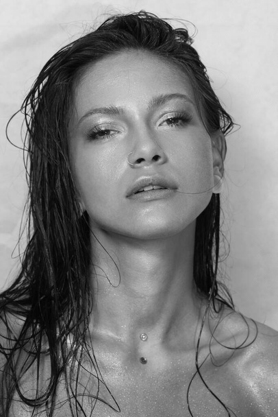 Close-up portrait of beautiful woman's purity face. Model with wet clean shiny skin. Small drops on the skin. Black and white photo. - Φωτογραφία, εικόνα