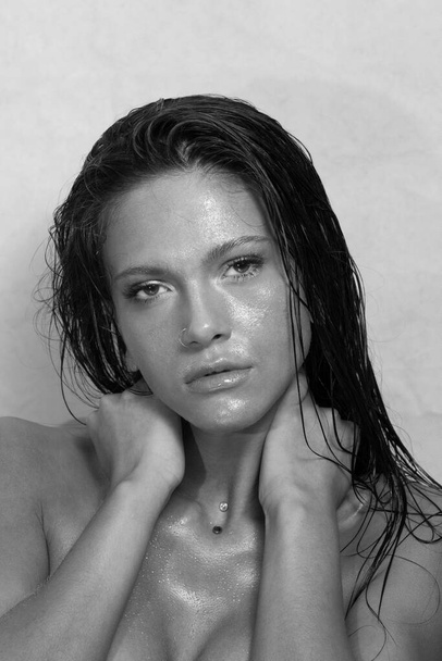 Close-up portrait of beautiful woman's purity face. Model with wet clean shiny skin. Small drops on the skin. Black and white photo. - Fotoğraf, Görsel