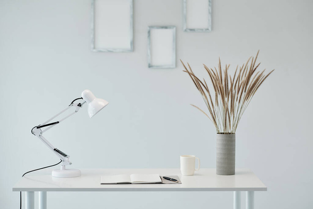 Desk of business person with planner, cup of coffee and lamp - Photo, Image