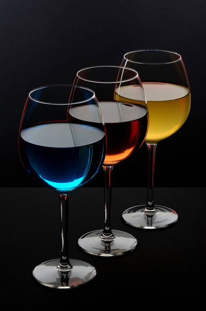three glasses of special drinks on a black background - 写真・画像