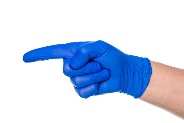 Crop hand of anonymous hand of doctor in latex glove pointing finger away against white background - Photo, Image