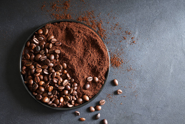 Roasted coffee beans and ground coffee on  gray background.  Copy space. Directly above.   - Фото, зображення