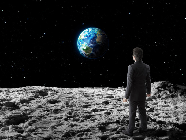 Businessman walks on moon surface - Zdjęcie, obraz